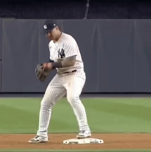 A New York Yankees Baseball Player Is Getting Ready To Catch A Ball GIF