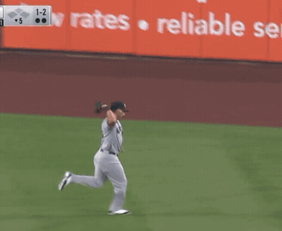 A New York Yankees Baseball Player Is Running Towards A Base GIF