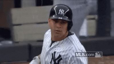 A New York Yankees Baseball Player Is Wearing A Black Helmet And A White And Black Uniform . GIF