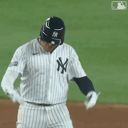 A New York Yankees Baseball Player Wearing A Black And White Striped Jersey GIF