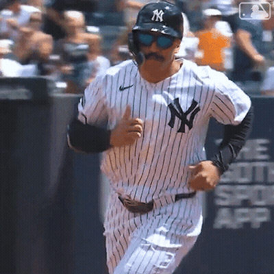 A New York Yankees Baseball Player Wearing Sunglasses And A Mustache Is Running On The Field GIF