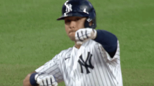 A New York Yankees Baseball Player Wears A Helmet With The Ny Logo On It GIF
