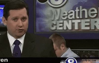 A News Anchor Stands In Front Of The Weather Center GIF