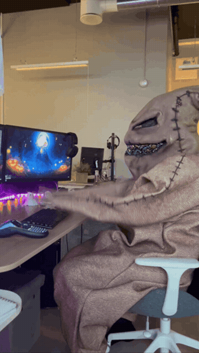 A Nightmare Before Christmas Character Is Sitting In Front Of A Computer Screen GIF
