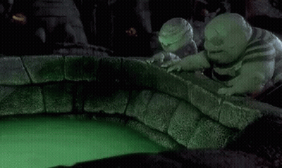A Nightmare Before Christmas Scene With A Glowing Ball In The Middle Of A Pool Of Green Liquid . GIF
