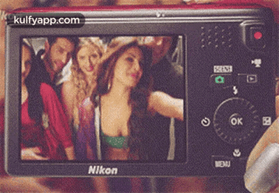 A Nikon Camera Shows A Group Of People Posing For A Picture GIF