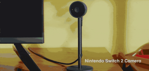 A Nintendo Switch 2 Camera Sits On A Desk Next To A Monitor GIF