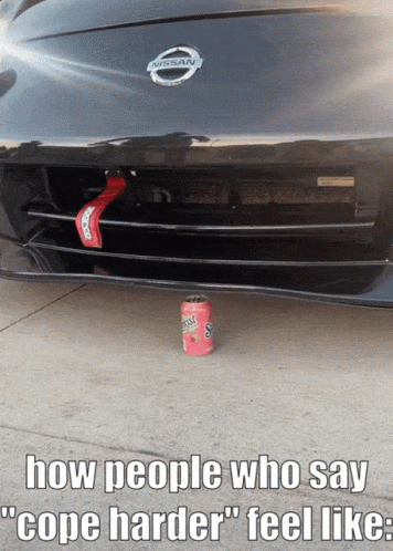 A Nissan Car With A Can Of Gatorade On The Ground Under The Bumper GIF