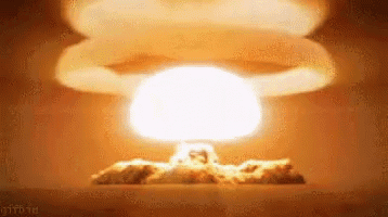 A Nuclear Explosion With A Huge Mushroom Cloud Coming Out Of It . GIF