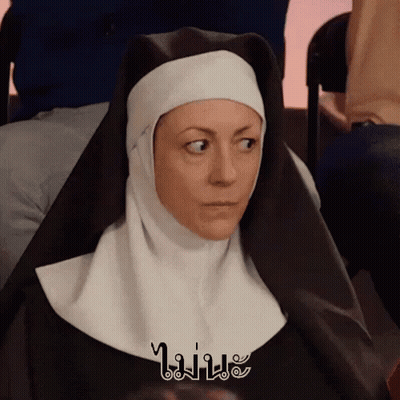 A Nun Is Sitting In A Chair With A Foreign Language Written On Her Head GIF