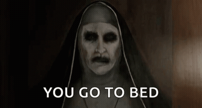 A Nun With Glowing Eyes And A Mustache Is Saying You Go To Bed . GIF