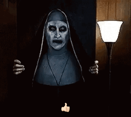A Nun With Glowing Eyes Is Giving A Thumbs Up Sign . GIF