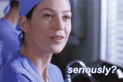 A Nurse Wearing A Blue Scrub Top And A Blue Hat Is Asking If She Is Seriously ? GIF