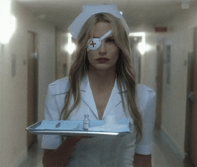 A Nurse With A Bandage On Her Eye Is Holding A Tray Of Supplies GIF