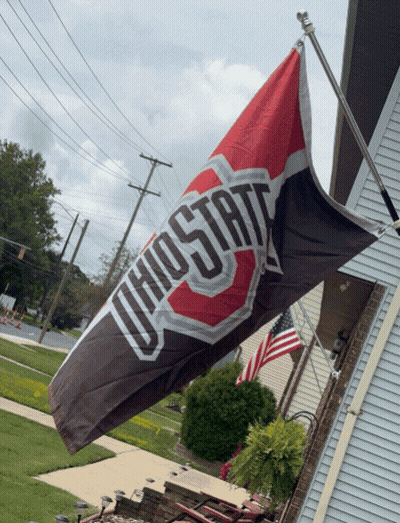 A Ohio State Flag Is Hanging From A Pole GIF