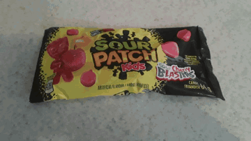 A Package Of Sour Patch Kids Candy Sitting On A Counter GIF