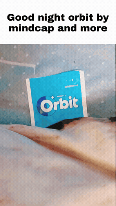 A Packet Of Orbit Gum Is Laying On A Bed GIF