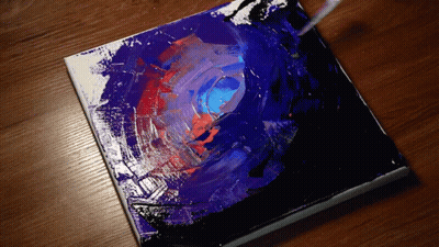 A Painting Is Being Painted On A Wooden Surface With A Brush GIF