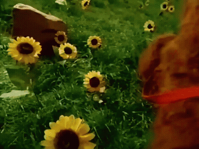 A Painting Of A Field Of Sunflowers With A Rock In The Background GIF