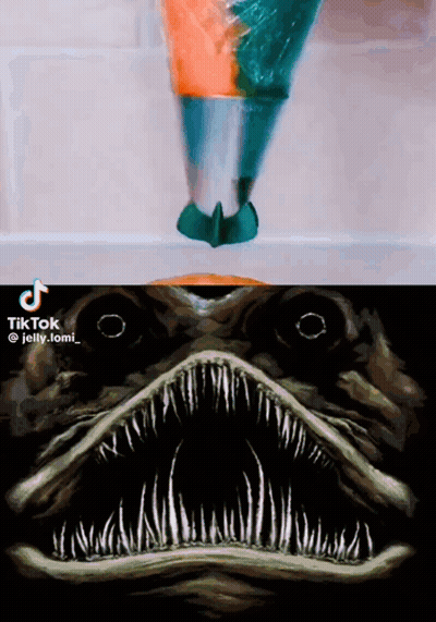 A Painting Of A Shark 'S Mouth Next To A Painting Of A Person 'S Head GIF