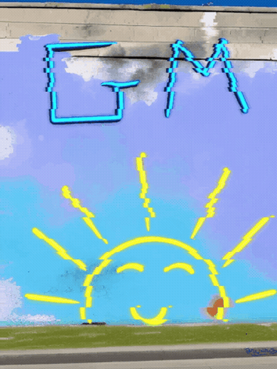A Painting Of A Sun And The Letter E On A Wall GIF