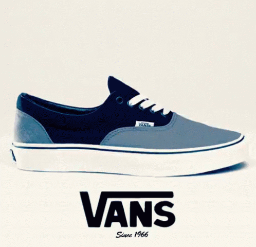 A Pair Of Blue And White Vans Shoes Are Displayed On A White Background GIF