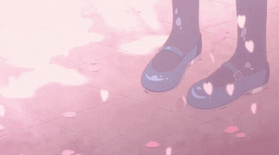 A Pair Of Blue Shoes On A Pink Tile Floor With Petals Falling From The Sky GIF