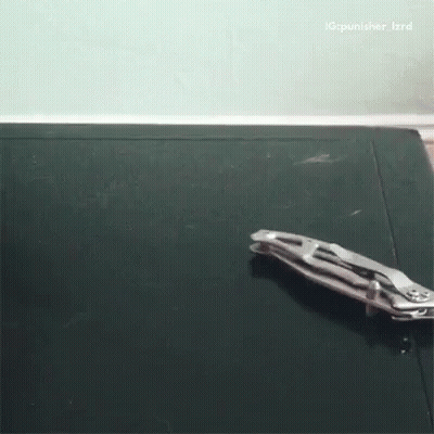 A Pair Of Pliers Laying On A Black Surface With A Caption That Says Ig Punisher_izrd GIF