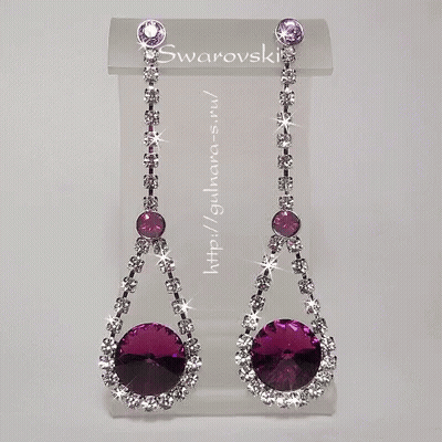 A Pair Of Purple And White Swarovski Earrings On Display GIF