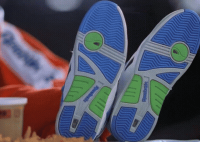 A Pair Of Reebok Shoes Are Laying On A Table GIF