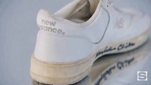 A Pair Of White New Balance Shoes With The Name Bin Clinton Written On It GIF