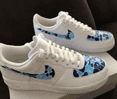 A Pair Of White Nike Air Force 1 Sneakers With A Blue Camo Pattern On Them GIF