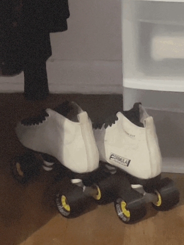 A Pair Of White Roller Skates That Say Formula On The Back GIF