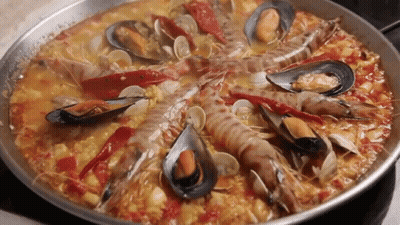 A Pan Filled With A Variety Of Seafood Including Shrimp Mussels And Peppers GIF
