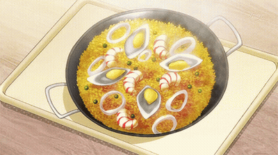 A Pan Filled With Rice And Seafood Is On A Table GIF