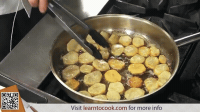A Pan Of Food Is Being Cooked On A Stove And The Website Learntocook.com Can Be Seen In The Corner GIF