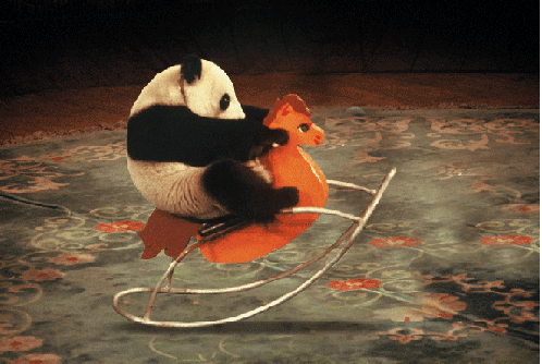 A Panda Bear Is Riding A Rocking Horse GIF