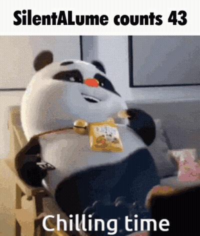 A Panda Bear Is Sitting On A Couch With A Bag Of Chips In His Mouth GIF