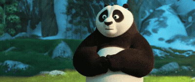 A Panda Bear Is Standing In A Field With His Arms Crossed And Looking At The Camera . GIF