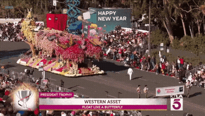 A Parade With A Float That Says President Trophy On It GIF