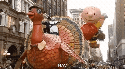 A Parade With A Turkey , Charlie Brown And A Pilgrim . GIF