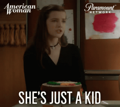 A Paramount Network Ad For American Woman Shows A Girl Standing Next To A Cake GIF