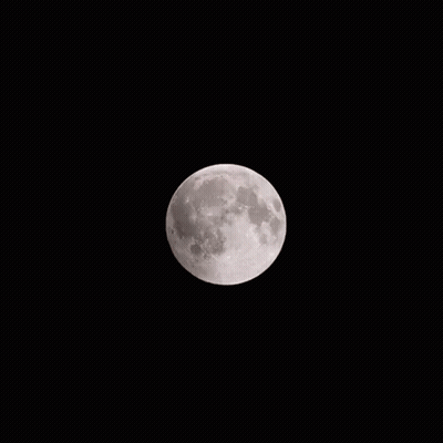 A Partial Eclipse Of The Moon Is Visible In The Dark GIF