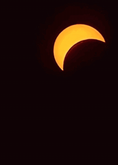 A Partial Eclipse Of The Sun Is Visible In The Night Sky GIF