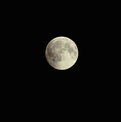 A Partial Lunar Eclipse With A Red Moon In The Dark GIF
