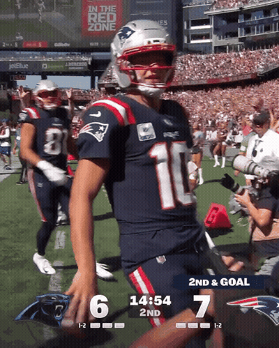 A Patriots Football Player Stands On The Field During A Game GIF