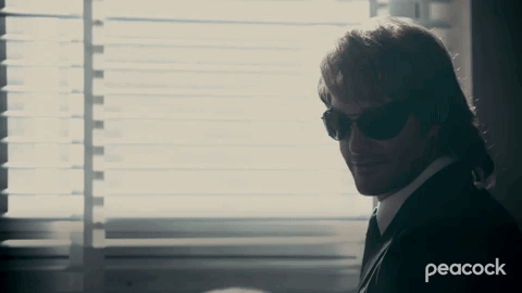 A Peacock Ad Shows A Man In A Suit And Tie GIF