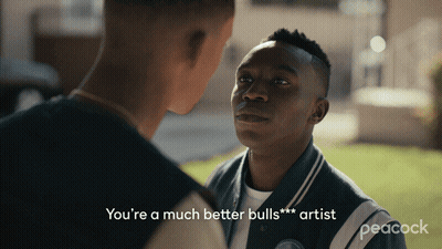 A Peacock Advertisement With Two Men Talking To Each Other GIF