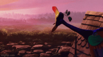 A Peacock With A Long Neck Is Standing In Front Of A Roof GIF
