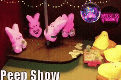 A Peep Show Is Being Advertised With A Disco Ball In The Background GIF